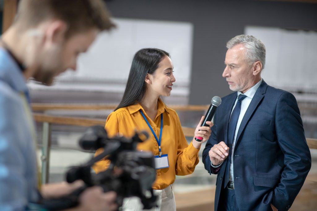 asian female reporter holding a microphone in her 2023 11 27 05 10 26 utc