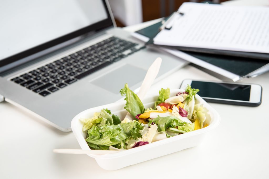 close up of fresh salad with laptop and smartphone 2023 11 27 05 17 00 utc