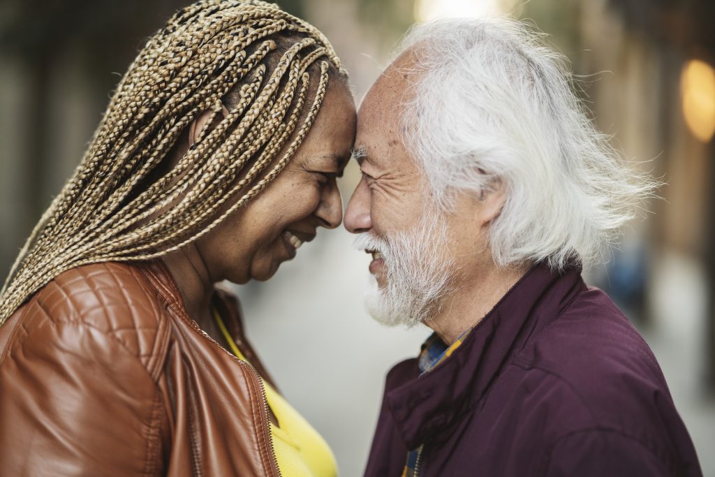 happy sop couple and senior husband in love, multiracial woman, asian man, looking each other in the face. concept of love retirement