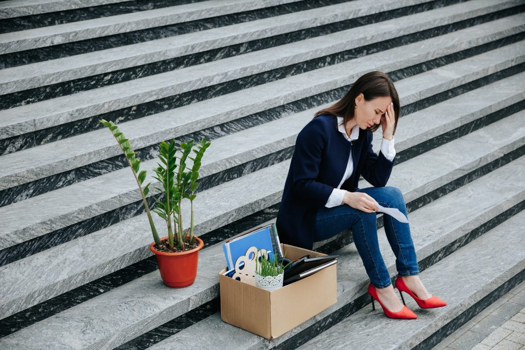 solitude in joblessness upset woman sitting alone
